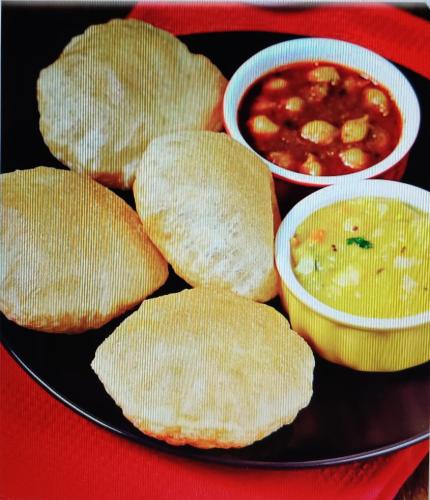 a plate of food with chips and a bowl of soup at Orchid Suites Apartments in Mysore