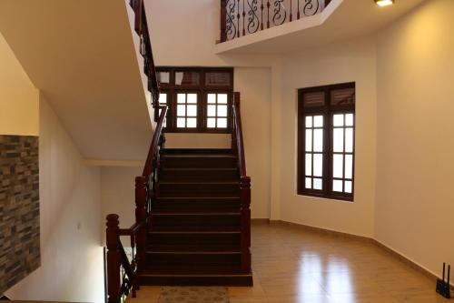 a staircase in a building with two windows at Kandy City Village in Kandy