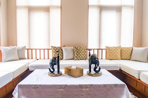 a living room with a couch and a table at Pawanthorn Samui - SHA Plus in Chaweng