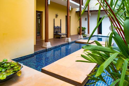 a swimming pool in a house with a resort at Pawanthorn Samui - SHA Plus in Chaweng