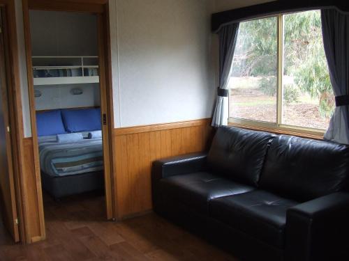 
a living room filled with furniture and a window at Western KI Caravan Park & Wildlife Reserve in Flinders Chase

