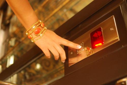 a woman is pointing at a red light at Hotel Hercegovina in Sarajevo