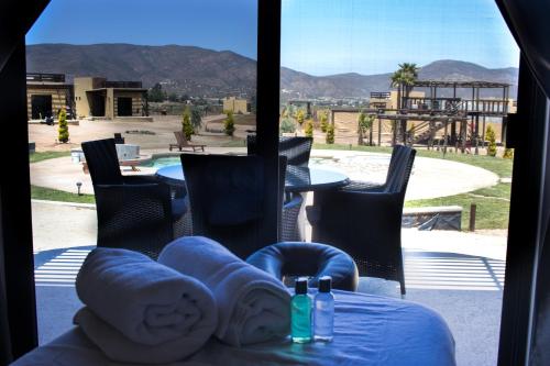 a view of a patio with a table and chairs at Cuatro Lunas Hotel Boutique in Valle de Guadalupe