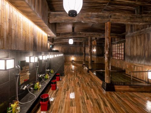 a large room with a wooden floor and wooden walls at La'gent Stay Hakodate Ekimae in Hakodate