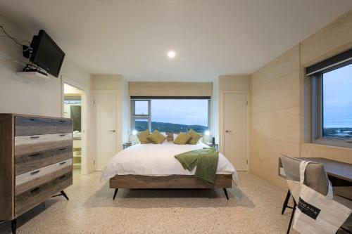 a bedroom with a bed and a large window at Saudade Margaret River in Margaret River Town