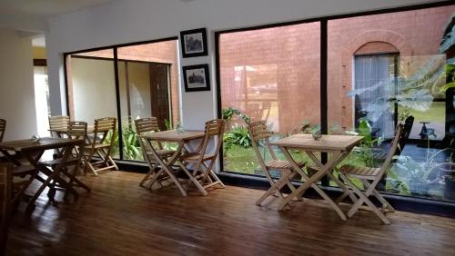 a group of tables and chairs in a room at SAHA NOFY Ambohimalaza Guest in Antananarivo