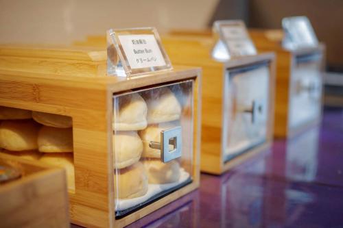 three boxes of bread in a display case at Green World ZhongXiao in Taipei