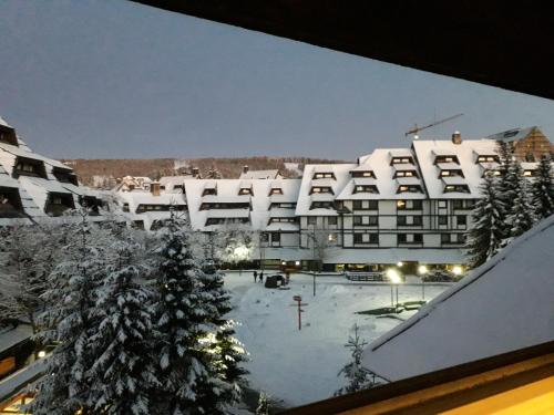a view of a building with a snow covered courtyard at Sweet Home Konaci in Kopaonik
