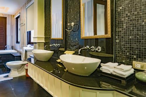 a bathroom with two sinks on a counter at Pawanthorn Samui - SHA Plus in Chaweng