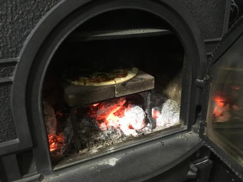 a pizza is being cooked in an oven at Santari in Shintoku