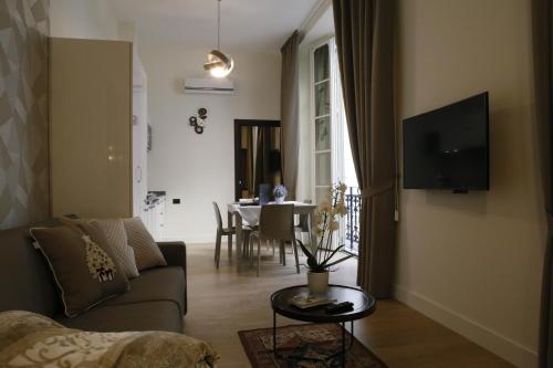 a living room with a couch and a table at Napoli Mariana Luxury in Naples
