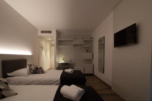 a hotel room with a bed and a television at Albergo Milano in Mendrisio