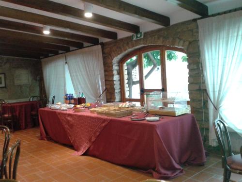 a table with a red table cloth in a room at Masseria Sant'Anna in Bari