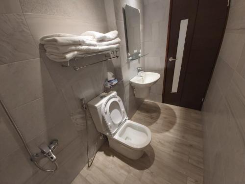 a bathroom with a toilet and a sink at Haichin&Haiting B&B in Donggang