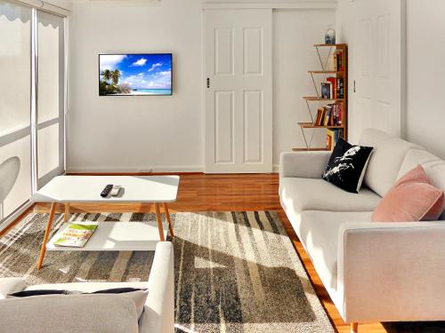 a living room with a couch and a table at Glen Iris, Quiet Boutique 2 bedroom Netflix, WIFI, Parking, Free Wine in Melbourne