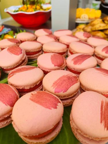 a bunch of pink cupcakes sitting on a table at Le Nautile Beachfront in Saint-Gilles les Bains