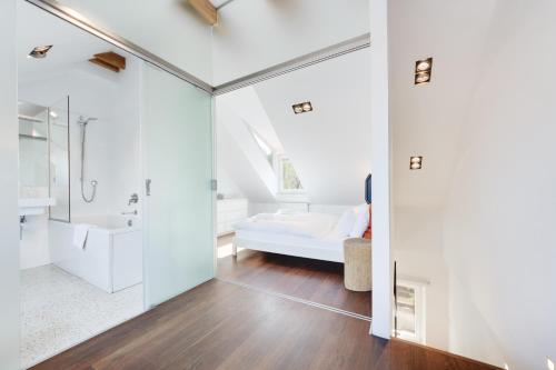 a bathroom with a shower and a bed in a room at Fine Ljubljana Apartments in Ljubljana