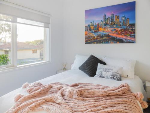 a bedroom with a white bed with a large window at Glen Iris, Quiet Boutique 2 bedroom Netflix, WIFI, Parking, Free Wine in Melbourne