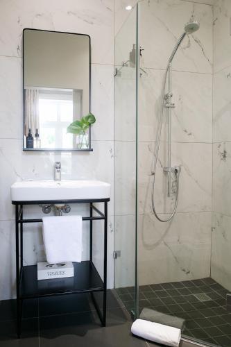 a bathroom with a sink and a shower at Bonne Esperance Boutique Guest House in Stellenbosch