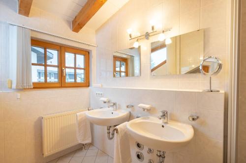 a white bathroom with a sink and a mirror at Ferienwohnung G. Füglein in Oberstdorf