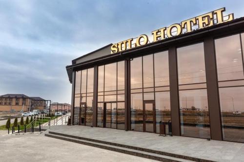 a store front with a sign on top of it at SULO Atyrau Hotel in Atyraū