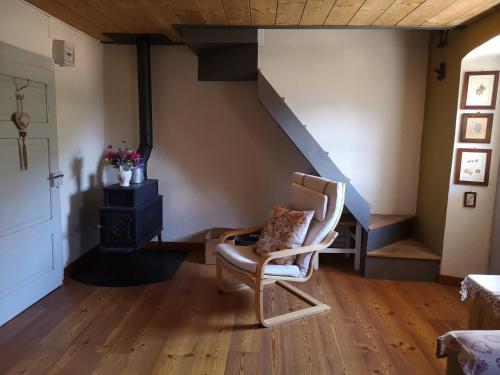 a living room with a chair and a staircase at San Carlo in Chiavenna