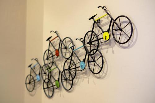 a group of bikes hanging on a wall at La maison du boulevard in Aosta