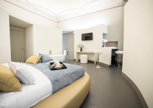 a bedroom with a large bed with a tray on it at LUCUS Exclusive Bed and Breakfast in Lucca
