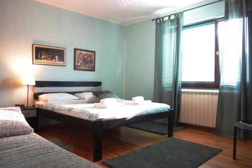 um quarto com uma cama e uma grande janela em Villa Quantum Beograd em Belgrado