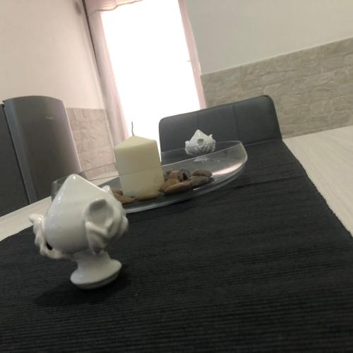 a table with a plate of cheese and candles on it at Scarparidd Home in Bari