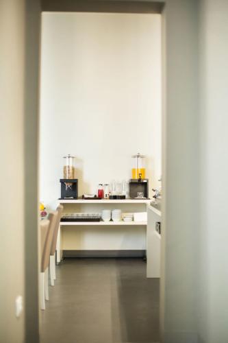 an open door to a kitchen with a counter at LUCUS Exclusive Bed and Breakfast in Lucca