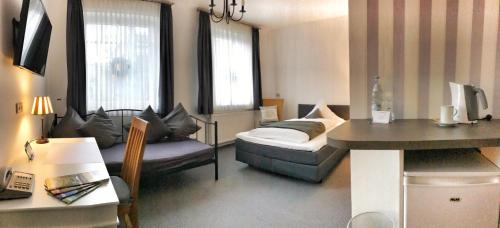 a small living room with a couch and a table at Hotel KAUP in Paderborn