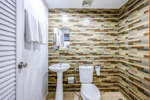 a bathroom with a toilet and a sink at Naiyang Place - Phuket Airport in Nai Yang Beach