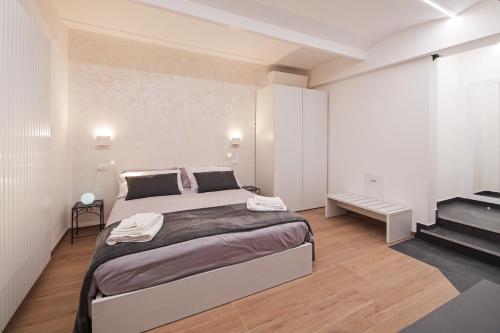 a bedroom with a large bed and a staircase at B&BO la Frasca in Bologna