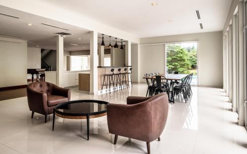 a living room with chairs and a table at Changkat Duta Luxury Villa (Event Space) in Kuala Lumpur