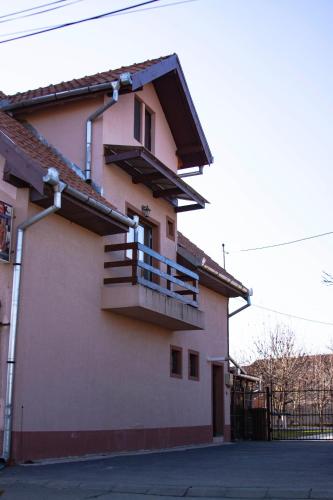 a building with a balcony on the side of it at Sport Hostel Cluj in Cluj-Napoca