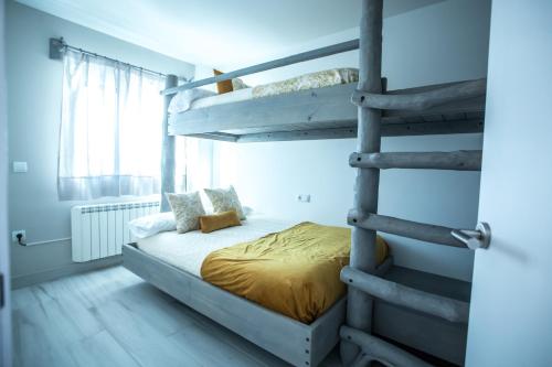 a bedroom with a bunk bed and a ladder at Luna in Sierra Nevada