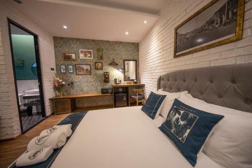 a bedroom with a large bed and a bathroom at Carnarvon Suites in George Town