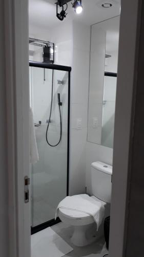 a white bathroom with a shower and a toilet at Time Home Service 1411 in Maceió