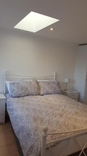 a bedroom with a large bed with a white ceiling at Executive Annex - Dunfermline in Dunfermline