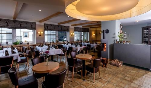 a restaurant with tables and chairs in a room at Harzer Hof in Herzberg am Harz