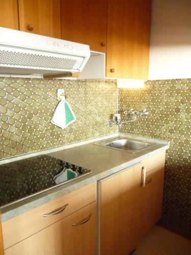 a kitchen with a sink and a counter top at STHS79125-FeWo-Oostseebreker in Staberdorf