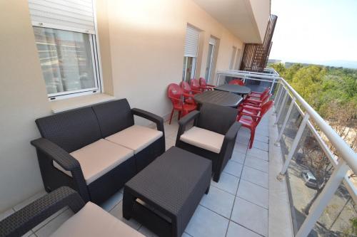 a balcony with chairs and a table and chairs at WVP - Ventura Park Z in Salou