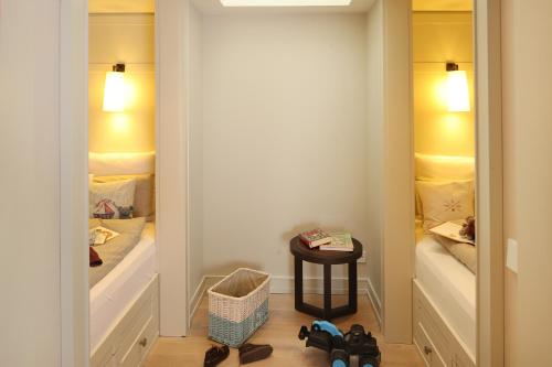 a small room with two beds and a table at Severin's Resort & Spa in Keitum
