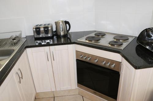 a kitchen with a stove top oven next to a sink at Kaliva 364 at Club Mykonos in Langebaan in Langebaan