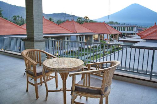a table and two chairs on a balcony at Seamount Hotel Amed in Amed