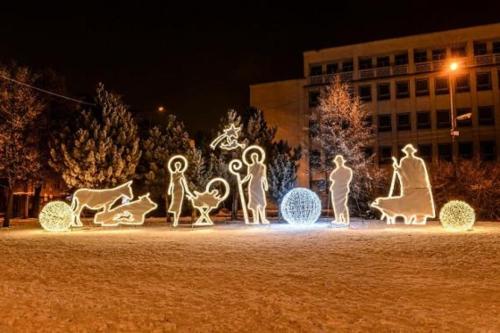 a group of illuminated figures of people and animals at night at APARTMENT A&D CENTRUM in Poprad