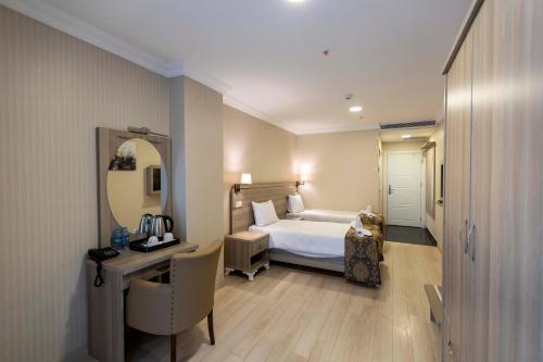 Postel nebo postele na pokoji v ubytování World Point Hotel Besyol