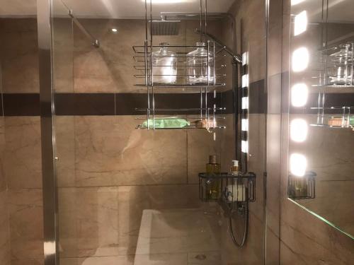 a bathroom with a shower with a glass door at The Waterside Rooms in Annan