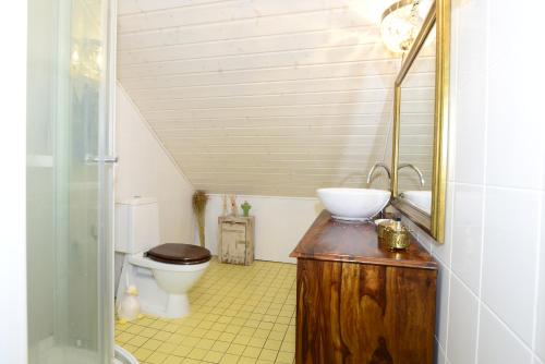 a small bathroom with a toilet and a sink at Guesthouse Torppa in Korkeakoski